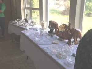 Table full of glassware at estate sale