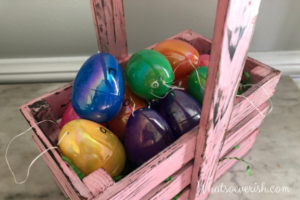 12 Easter eggs in a wooden basket