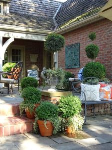 Brick patio with a variety of terra cotta pots
