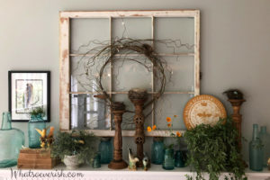 Mantel with old window, plant, candlesticks, etc