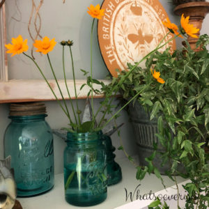Blue mason jar with yellow-orange flowers